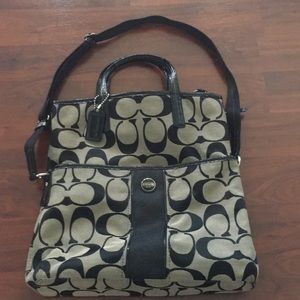 Black and grey coach purse with cross body strap.